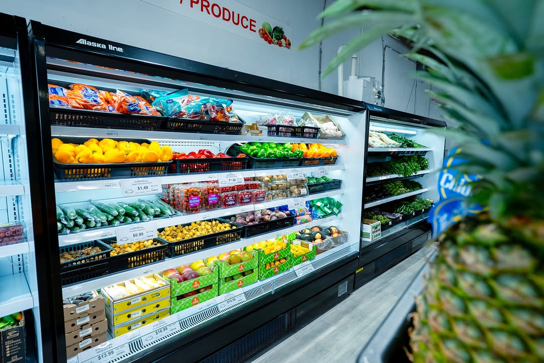 Refrigerated fresh produce display with fruits and vegetables at Tomatoes Bazar